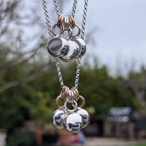 Sterling silver blob pendant with 9ct yellow gold rings