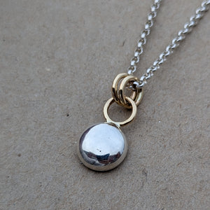 Sterling silver blob pendant with 9ct yellow gold rings